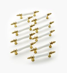 a bunch of white and gold screws on a white background