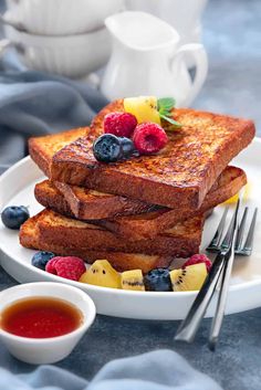 french toast on a plate with berries and blueberries