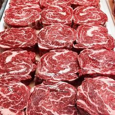 raw meats are laid out in rows on display