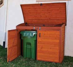 an open wooden storage box with a green trash can