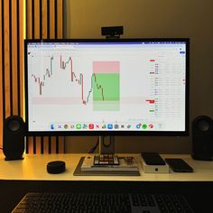 a computer monitor sitting on top of a wooden desk next to a keyboard and mouse