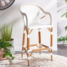 a white chair sitting on top of a rug next to a clock