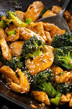 chicken and broccoli with sesame seeds in a skillet