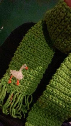 a green scarf with a white duck on it