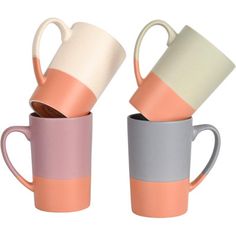 three different colored coffee mugs sitting next to each other