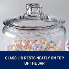 glass lid rests neatly on top of the jar filled with colorful candies and candy