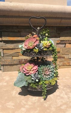 three tiered planter with succulents and greenery