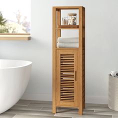 a white bath tub sitting next to a wooden shelf