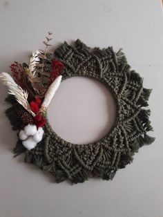 a green wreath with white and red decorations