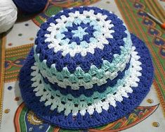 three crocheted hats sitting on top of a table