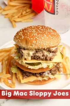 a big mac sloppy joe on a plate with french fries and a drink in the background