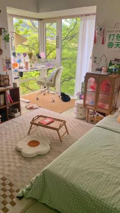 a bedroom with a bed, desk and window overlooking the trees in the distance is shown