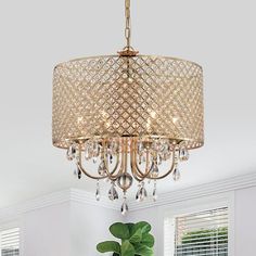 a chandelier hanging from the ceiling in a room with white walls and windows