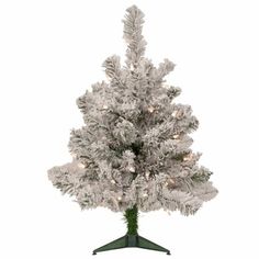 a white christmas tree with lights on it