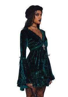 Be heavenly in this stretchy crushed velvet mini dress which has tiered bell sleeves, interlocking ribbon detailing, a ruffled trim, a plunging neckline, a cross charm on the front, and a tiered skirt. Velvet Ruffle Mini Dress, Emerald Velvet, Dress With Bell Sleeves, Velvet Mini Dress, Mini Velvet Dress, Bell Sleeve Dress, Cross Charms, Crushed Velvet, Tiered Skirt