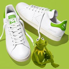 The Adidas Stan Smith Kermit Is A Limited Edition Sneaker That Pays Homage To The Iconic Muppet Character. Sizing Info: Men: Us 7.5 Women: Us 8.5 Heel To Toe: 9.8” Product Details: Limited Edition! Classic Low-Top Tennis Shoe. White Leather Upper. Lime Green Accents On The Heel Tab, Tongue, & Insole. Perforated “K” On The Sides. “It’s Not East Being Green” Stitched On The Heel. The Kermit Graphic Is Prominently Displayed On The Tongue - Adding A Playful Touch To The Classic Silhouette. Made With Casual Custom Sneakers With Adidas Logo, Green Mid-top Custom Sneakers With Cushioned Footbed, Casual Green Moisture-wicking Sneakers, Green Mid-top Synthetic Sneakers, Green Synthetic Slip-on Sneakers With Round Toe, Green Synthetic Slip-on Sneakers For Sports, Sneaker Pics, Low Top Tennis Shoes, Limited Edition Sneakers