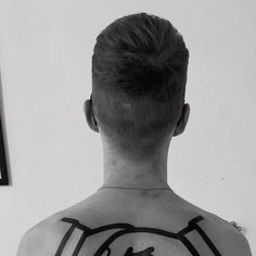 a man with a tattoo on his back