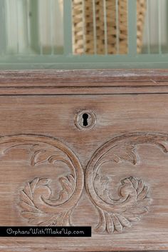 an old wooden cabinet with carvings on it