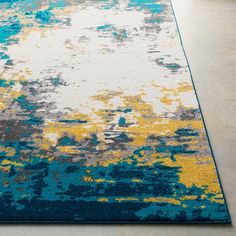 a blue and yellow area rug on the floor with white, gray, green, and yellow colors