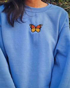 This Carolina blue crewneck is embroidered with an orange and yellow Monarch butterfly. Whether it's for yourself or a gift, get cozy, comfy, and stylish with this embroidered sweatshirt. Crewnecks are embroidered with a one-of-a-kind design inspired by places, experiences, and adventures! ⭐  PRODUCT DETAILS * Unisex Sizing * Sweatshirts: 50% cotton, 50% polyester * T-Shirts: 100% cotton * Size up 1-2 sizes for a looser comfy fit ⭐  CARE INSTRUCTIONS Wash with cold water. Hang drying is recommen Blue Hoodie Embroidery, Casual Embroidered Crew Neck Hoodie, Cute Blue Crew Neck Hoodie, Blue Sweatshirt For Spring, Comfortable Blue Sweatshirt For Spring, Comfortable Blue Sweatshirt For Fall, Blue Hoodie With Custom Embroidery, Blue Custom Embroidered Hoodie, Blue Long Sleeve Hoodie With Custom Embroidery