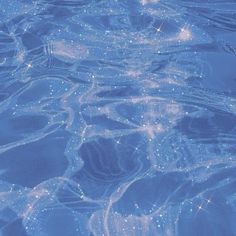 an image of water that is very blue and has bubbles on the surface in it