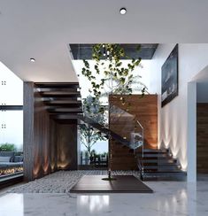 a modern staircase with glass railings leading up to the second floor and an indoor tree in the center