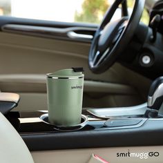 a cup sitting on the dashboard of a car