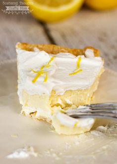 a piece of lemon meringue pie on a plate with a fork