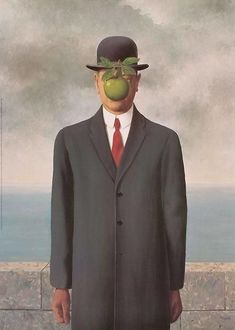 a man in a suit and hat standing next to a painting with an iphone on his head