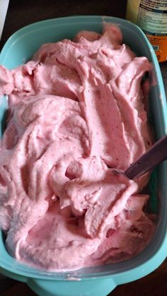 a bowl filled with pink ice cream sitting on top of a table