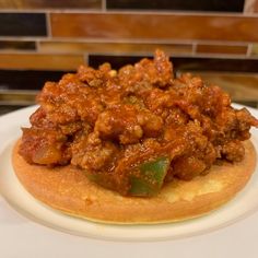 a close up of a plate of food on a counter top with a tile wall in the background