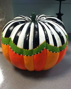 a painted pumpkin sitting on top of a table