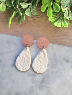 Beautiful White Teardrop Earrings are made of leaf stamped polymer clay, in a flattering teardrop shape, accented with a stained wood stud, and finished with stainless steel posts. Super Lightweight and comfortable to wear all day. They measure about 1.5" in height. Want something different? I am happy to make these in a different colorI LOVE custom orders. Be sure to check out my shop for many more designs available. Follow my shop for updates each time I add new designs. Thanks so much for looking 😘 Earrings Leaf, Wood Studs, Earrings Teardrop, Stained Wood, Earrings Polymer Clay, Earrings Wedding, Earring Patterns, Wedding Earrings, Bridal Earrings