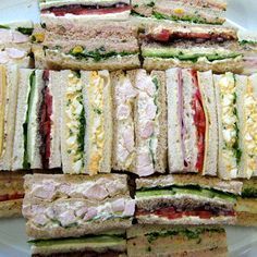 a platter filled with sandwiches on top of a white plate