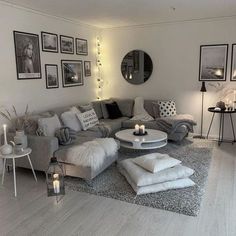 a living room filled with lots of furniture and pictures on the wall above it's coffee table