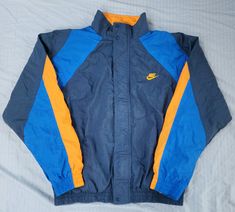 Vintage 1980s Nike 2 Tone Blue Orange Track Jacket  In great condition  Normal wear  9.5/10 Medium 26 x 25 Pit to Pit Any questions feel free to reach out! Retro Blue Windbreaker For Fall, Blue Retro Windbreaker For Fall, 90s Blue Windbreaker For Fall, Vintage Blue Windbreaker For Fall, Vintage Blue Long Sleeve Windbreaker, Vintage Blue Windbreaker For Winter, Sun Valley, Nike Blue, Track Jacket