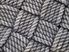 gray rope is piled together in this close up photo, as if it were used to make a background