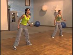 two women are doing exercises in an exercise room while one woman is on the phone