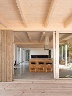 an open living room and dining area with sliding glass doors