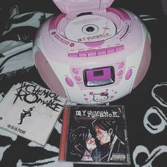 a cd player and some books on a bed