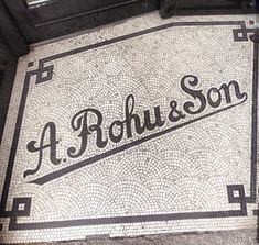 a mosaic tile floor with the word'a rouhson'written on it