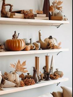 the shelves are filled with pumpkins and other decorations