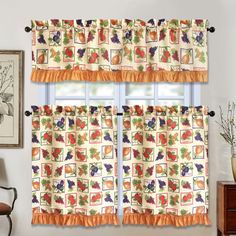 a kitchen window curtain with fruit and vegetables printed on the top, along with an orange valance