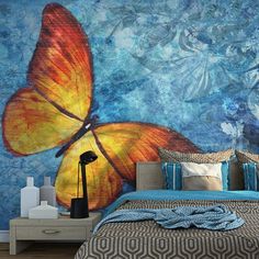 a bedroom with a butterfly painted on the wall