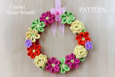 a crocheted wreath with flowers on it