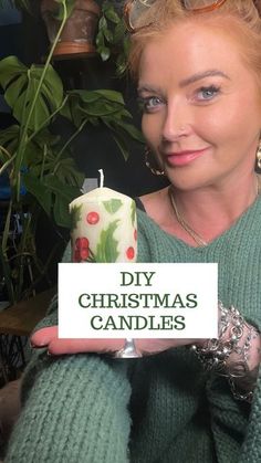 a woman holding a candle with the words diy christmas candles