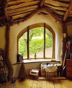 an open window in a room with wood flooring and wooden beams on the ceiling