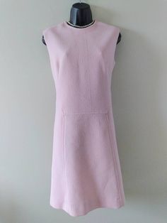 Beautiful Mod style shift dress from the 60's Designer Jontel and made with the patented Diolen Loft Fabric. Fully lined Back metal Zipper (works well but seems stiff) Pair it with some pearls and gloves,maybe a hat and you will look Glam! In excellent condition with 1 tiny spot on front,shown in photo,will likely come out. Tag says UK size 18 Bust 39-41 Hips 41-43 Full length 39 inches Mod Style Fitted Dresses For Daywear, Fitted Mod Dresses For Daywear, Sleeveless Mod Dresses For Daywear, Pink 60s Dress, Retro Pink Dress With Button Closure, Vintage Pink Collared Dress, 1960s Pink Dress, Pink Vintage Dress With Button Closure, 1960s Shift Dress