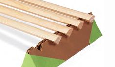 a close up of some wood planks on a white background with green tape around them