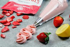 strawberries, lemon and strawberry ice cream are on the counter next to a bag of nuts